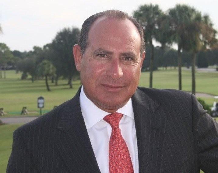 A man in a suit and tie standing outside.