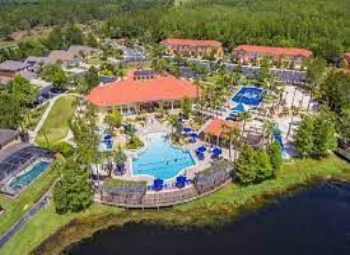 A resort with many pools and a large pool deck.