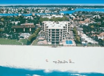 A view of the beach from above shows a large building.